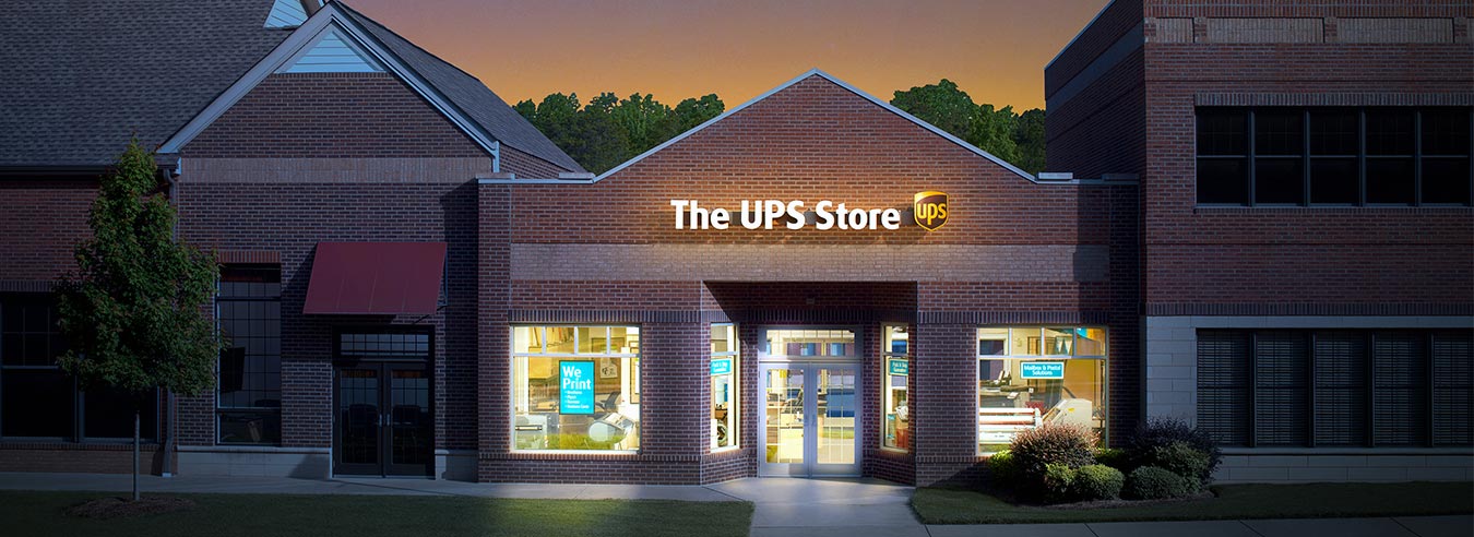 Exterior photo of a The UPS Store location at night